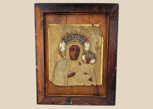 19th-century Eastern European icon depicting Our Lady of Częstochowa holding the Christ Child beneath an ornate metal riza.