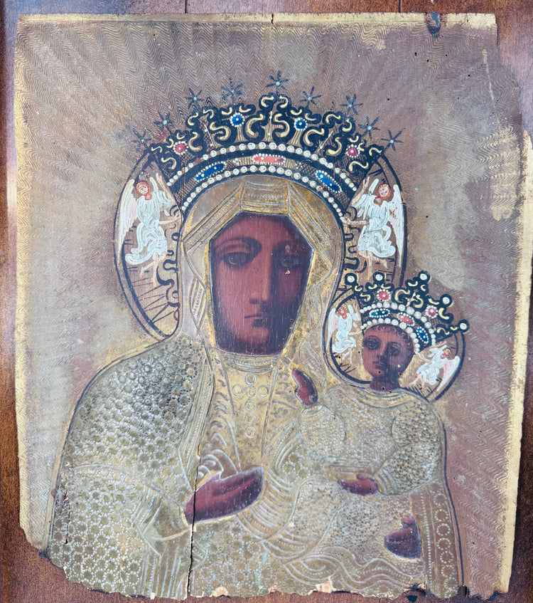 Eastern European religious icon featuring the Virgin Mary and Christ Child with repoussé metal ornamentation.