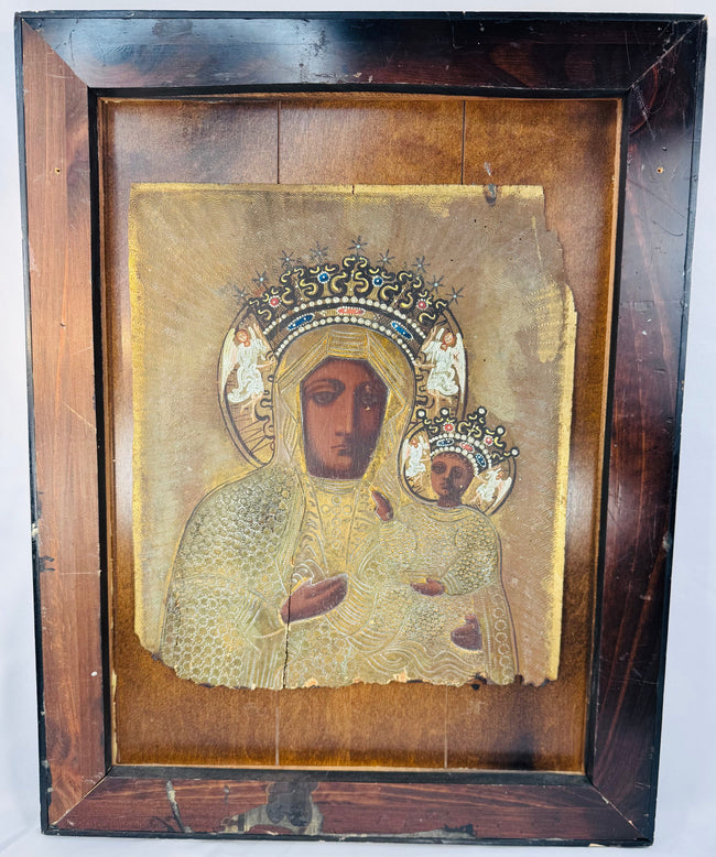 Black Madonna devotional icon with embossed metal revetment, jeweled crowns, and decorative halo motifs.