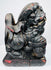 Close-up of individual Chinese guardian lion with fierce expression, exposed teeth, stylized mane and red pigment traces