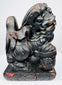 Close-up of individual Chinese guardian lion with fierce expression, exposed teeth, stylized mane and red pigment traces