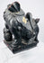 Angled view of antique Qing Dynasty guardian lion showing carved brocade ball, ornamental collar and lotus-petal base