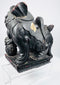 Angled view of antique Qing Dynasty guardian lion showing carved brocade ball, ornamental collar and lotus-petal base