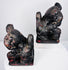 Three-quarter view of Qing Dynasty Chinese guardian lions showing carved collars, rounded pendants and aged lacquer surfaces