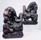 Front view of matched Chinese guardian lions showing open mouths, bulging eyes, carved manes and lotus-patterned bases