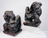 Side view of antique Chinese wooden guardian lion pair displaying raised tails, muscular bodies and deeply carved manes