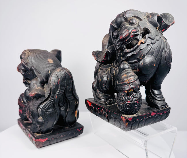Opposite side view of Chinese guardian lions showing mirrored poses, brocade balls and surviving red polychrome decoration