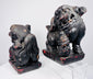 Opposite side view of Chinese guardian lions showing mirrored poses, brocade balls and surviving red polychrome decoration