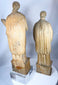 Hand-carved Christian figures with intricate robe decoration and centuries of aged character.