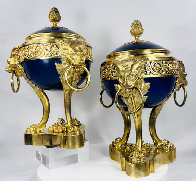 Elegant pair of antique Louis XVI Revival ormolu-mounted porcelain vases with lion mask ring handles.