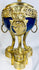 Decorative French ormolu and porcelain vase with openwork gallery, pinecone finial, and Classical design elements.