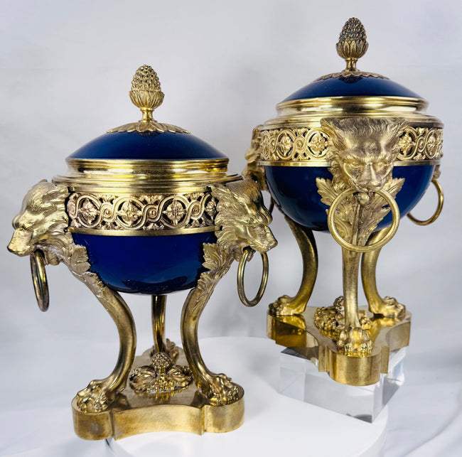 Pair of French Belle Époque porcelain and ormolu vases raised on finely cast lion-form legs.