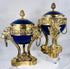 Pair of French Belle Époque porcelain and ormolu vases raised on finely cast lion-form legs.