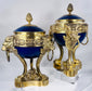 Pair of French Belle Époque porcelain and ormolu vases raised on finely cast lion-form legs.