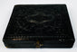 Closed mid-19th-century cased photograph with molded dark exterior, ornamental design, and metal clasp