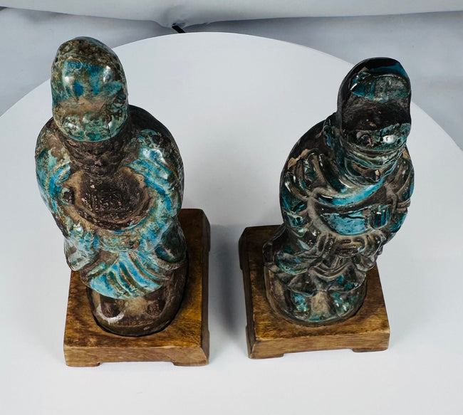Late imperial Chinese glazed attendants with ritual attributes and bracket-form bases