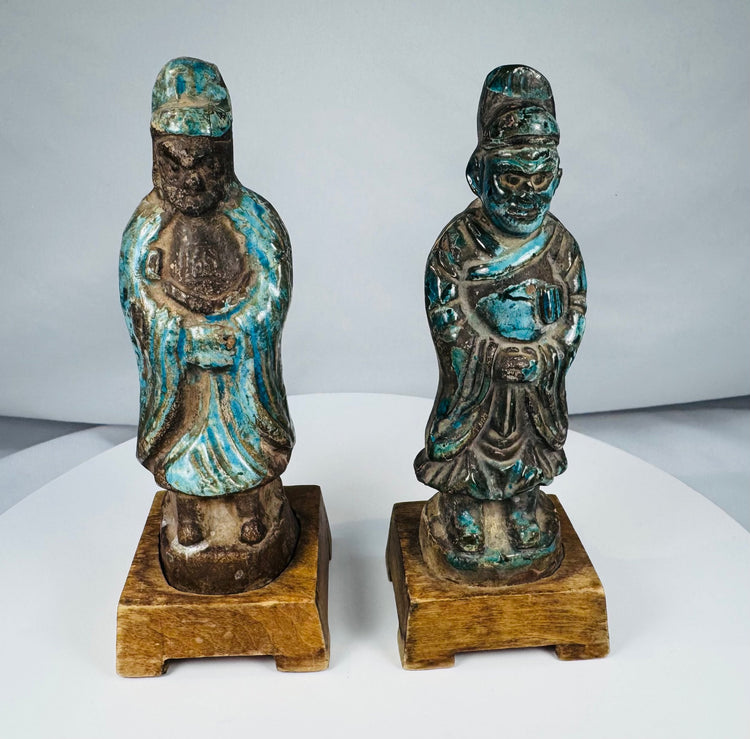 Chinese ceramic officials with tall headdresses, ceremonial objects, and weathered glaze