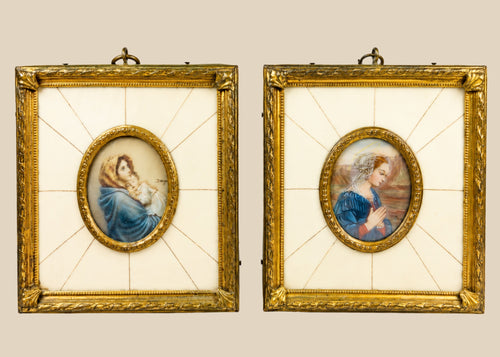 Pair of 19th century hand-painted miniature portraits in gilt frames with ivory-style panel insets. Depicting devotional female figures, one in prayer and one cradling a child. Original rectangular frames with oval portrait centers, fine detail and patina.
