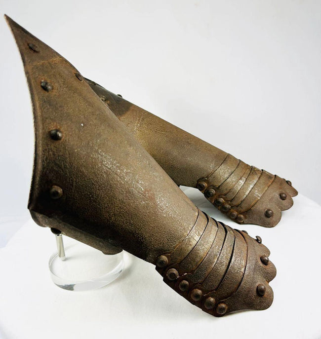 Close-up of articulation and engravings on Gothic-style steel gauntlets.