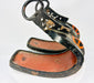 Pair of antique Japanese lacquered samurai stirrups with ornate cutout designs, red lacquer interiors, and cross-in-circle mon crests, Edo–Meiji period craftsmanship displayed on a white background.