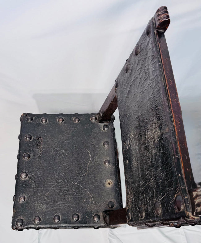 Historic Spanish chairs with naturally patinated leather and dark wood frames