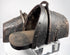Close-up of hand-forged iron stirrup with suspension loop, rivets and aged leather lining