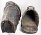 Pair of 400-year-old Iberian cavalry stirrups with dark oxidized iron patina