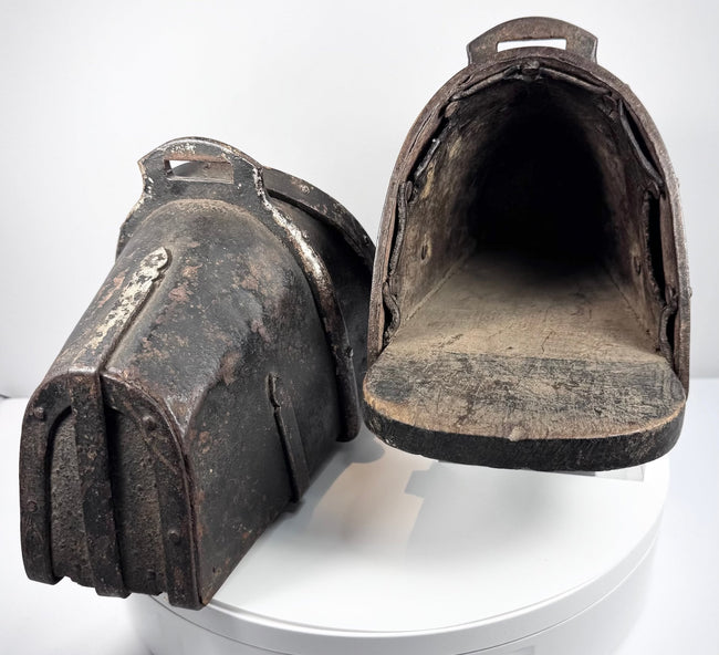 Interior view of an antique armored cavalry stirrup with surviving lining remnants and footplate
