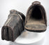 Interior view of an antique armored cavalry stirrup with surviving lining remnants and footplate