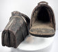 Interior view of an antique armored cavalry stirrup with surviving lining remnants and footplate