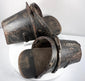 Front view of enclosed Spanish-style stirrups showing wooden footplates and protective hoods