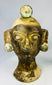 Antique-style Central American terracotta head sculptures showing textured surfaces and wear