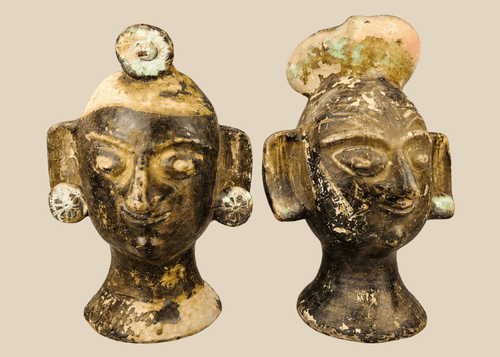 Pair of Pre-Columbian–inspired terracotta head sculptures with headdresses and ear discs, 20th century
