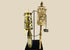 Pair of Tibetan prayer wheels, late 19th century, hand-carved bone, brass, and wood with Buddha figure, mantra script, floral motifs, and custom stands.