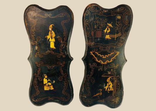 Pair of 19th-century Chinoiserie wall panels with hand-painted Asian-inspired figures, floral motifs, and gilt decoration on shaped black lacquered wood, circa 1850–1880.