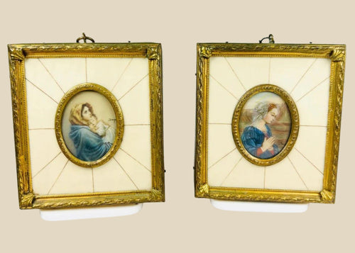 Pair of 19th century hand-painted miniature portraits in gilt frames with ivory-style panel insets. Depicting devotional female figures, one in prayer and one cradling a child. Original rectangular frames with oval portrait centers, fine detail and patina.
