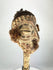Front view of 19th-century Papua New Guinea bone dagger featuring anthropomorphic carved head, cowrie shells, and ritual hair adornment.