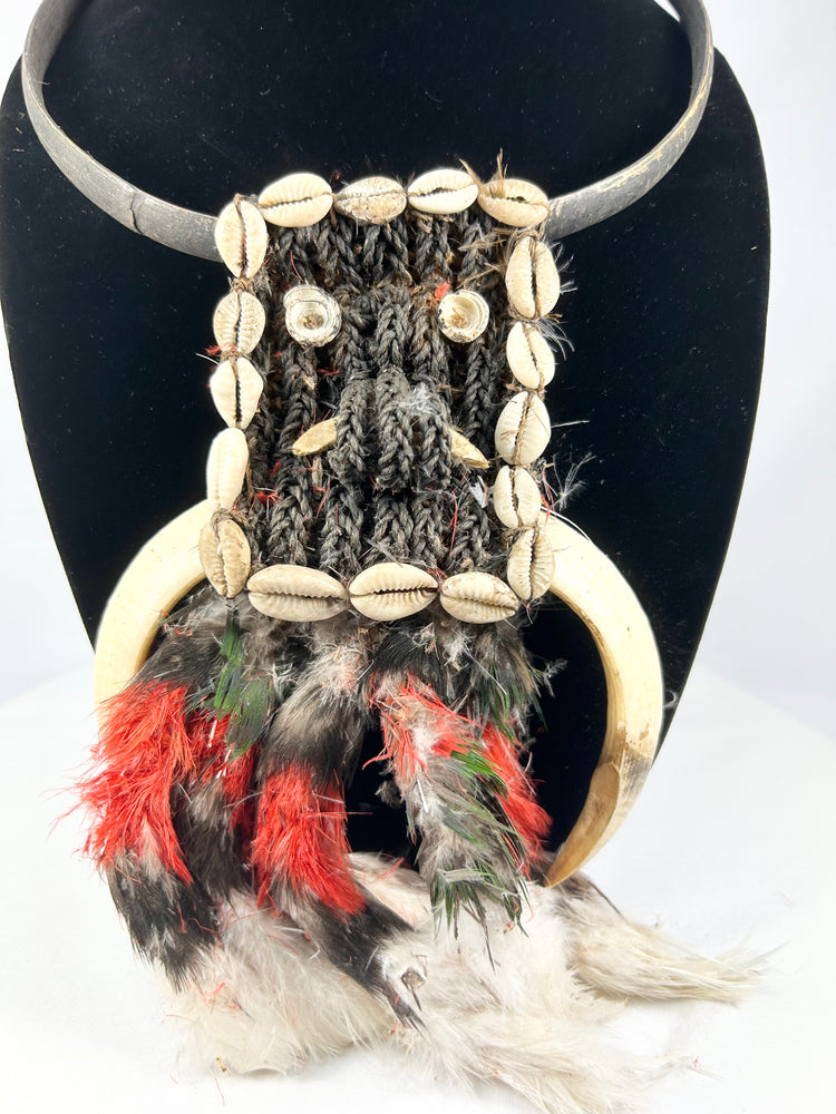 20th century Papua New Guinea tribal ceremonial necklace, braided plant fiber with shell and bone elements, red and black feathers, Oceanic ritual ornament, mounted for display