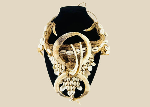 Early 20th century Papua New Guinea ceremonial apron, featuring boar tusks, cowrie shells, and natural fiber bindings, used in tribal initiations and dances, ethnographic Melanesian artifact