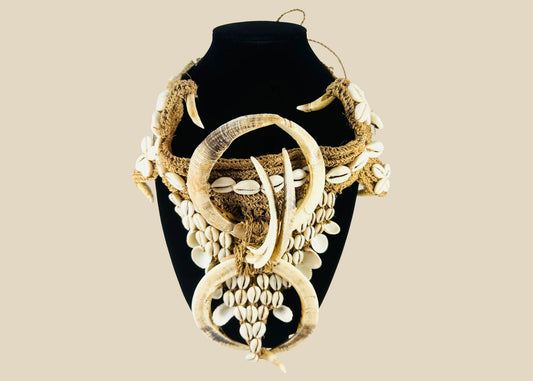 Early 20th century Papua New Guinea ceremonial apron, featuring boar tusks, cowrie shells, and natural fiber bindings, used in tribal initiations and dances, ethnographic Melanesian artifact