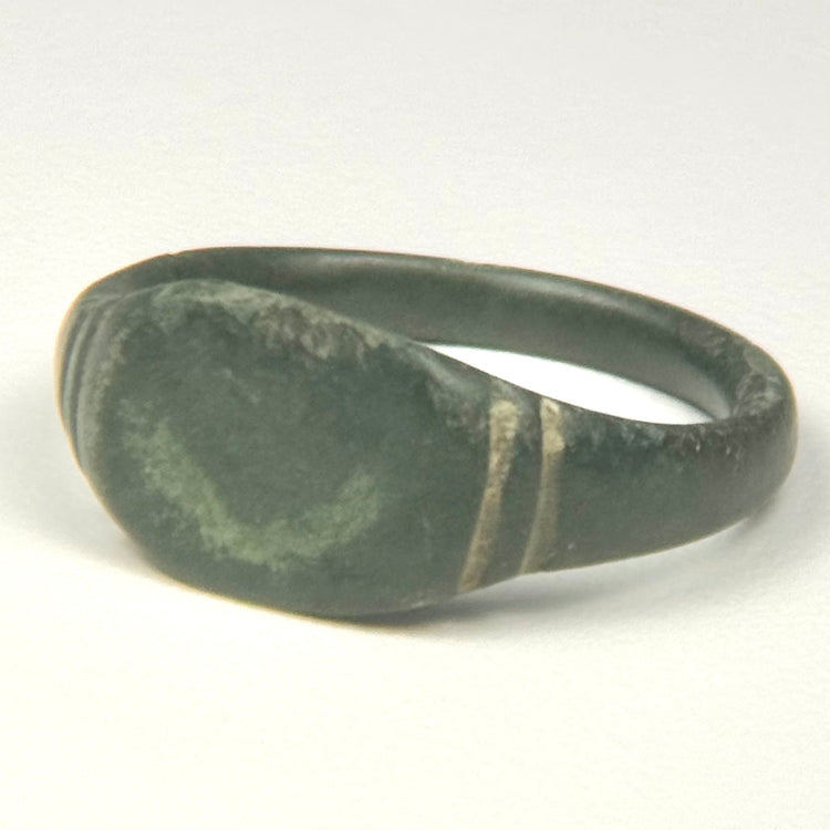 Side view of ancient Roman bronze finger ring with rounded hoop and expanding shoulders, US size 9