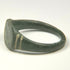 Close-up of Roman bronze ring bezel with olive-green patina, mineral deposits, and age-related surface wear