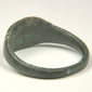 Ancient Roman copper-alloy finger ring with broad oval face and double transverse shoulder grooves