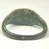 Roman Imperial bronze ring displaying dark olive and black patina with lighter green mineralization