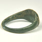 Profile view of ancient Roman bronze ring showing solid cast construction and thick expanding shoulders