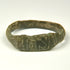 Ancient Roman bronze ring showing broad flattened bezel with incised vertical and diagonal decoration