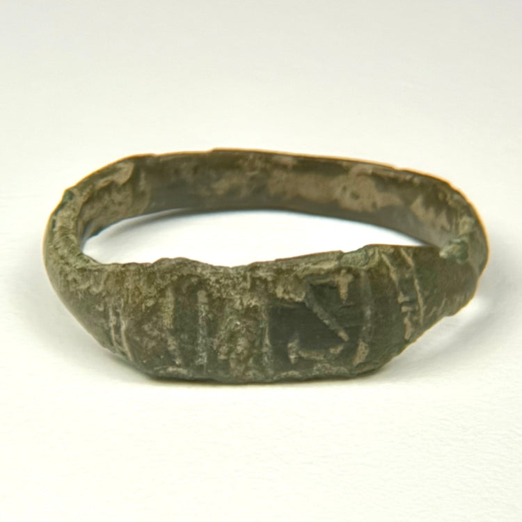 Ancient Roman bronze ring showing broad flattened bezel with incised vertical and diagonal decoration
