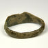Ancient Roman finger ring with incised linework, surface mineralization, and weathered bronze texture
