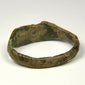 Ancient Roman finger ring with incised linework, surface mineralization, and weathered bronze texture