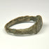 Rear view of ancient Roman bronze finger ring with irregular archaeological surface and surviving patina